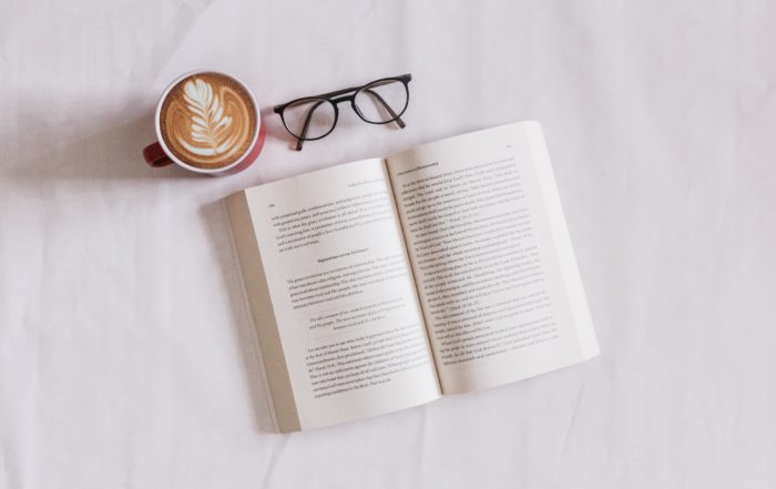 book near eyeglasses and cappuccino